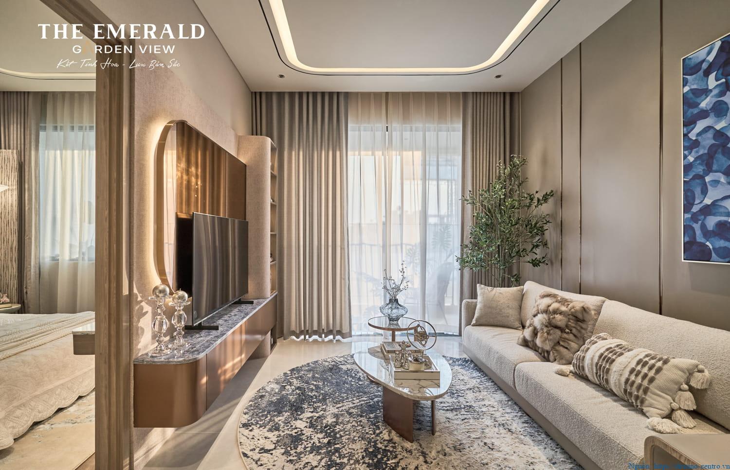 Phòng khách căn hộ mẫu 1PN+1 The Emerald Garden đặt cạnh ban công, tầm nhìn ra ngoài và nội thất bố trí gọn gàng